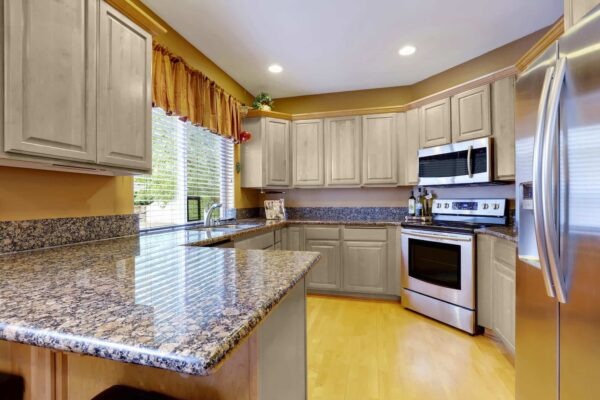 Brown Granite Countertops And Wheat Cabinets
